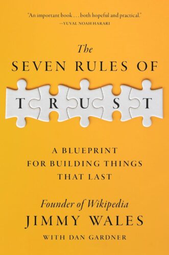Book cover with an orange background showing puzzle pieces forming the word TRUST. Title: The Seven Rules of Trust by Jimmy Wales with Dan Gardner. Endorsement by Yuval Noah Harari at the top highlights Jimmy Wales's insights.