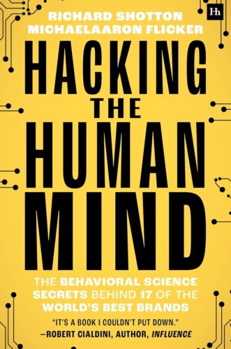 Book cover for Hacking the Human Mind by Richard Shotton & MichaelAaron Flicker, featuring bold black and white text on a yellow background with circuit-like designs in the corners.