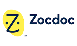 Zocdoc logo with a stylized dark blue Z and two dots forming a smiley face on a yellow oval, next to the word Zocdoc in dark blue text.