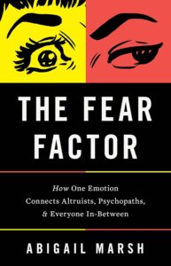 Book cover for The Fear Factor by Abigail Marsh featuring illustrated eyes with surprised and neutral expressions on yellow and red backgrounds, and the subtitle about emotion connecting altruists and psychopaths.