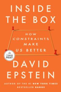 Book cover of Inside the Box: How Constraints Make Us Better by David Epstein. The title appears inside a string-and-push-pin box on an orange background, highlighting David Epstein’s name. Includes a Large Print sticker.